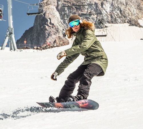 A snowboarder riding an all-mountain board