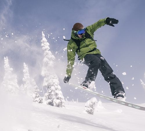 A snowboarder riding a freeride board