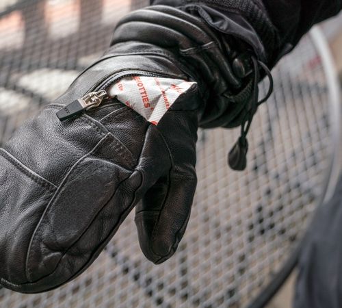 A snowboarder wearing mittens with handwarmer packets