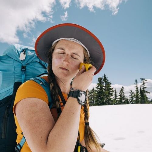 female-backpacker-applies-sunscreen-to-her-face-royalty-free-im_p70009